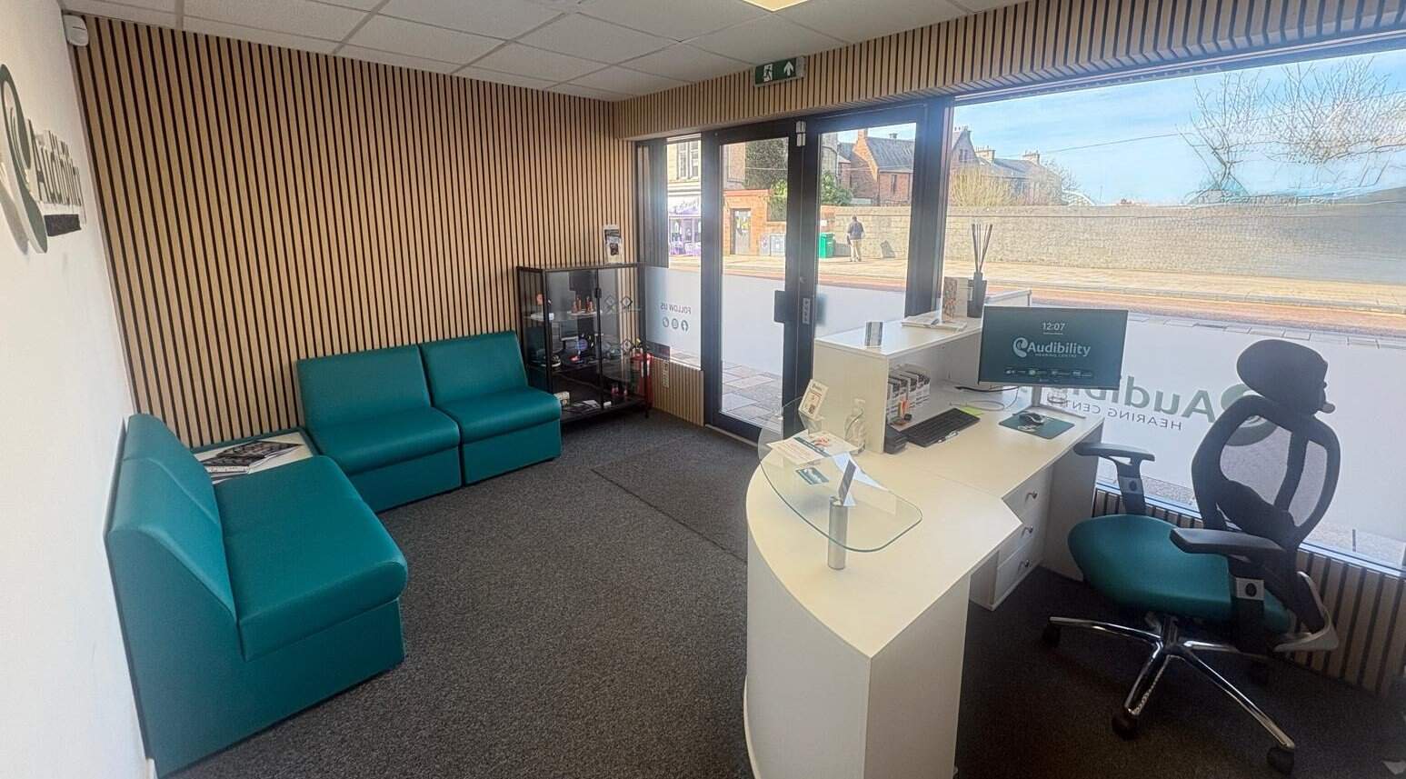 Audibility Hearing Centre reception area in Motherwell, showing a warm and welcoming space for patients.