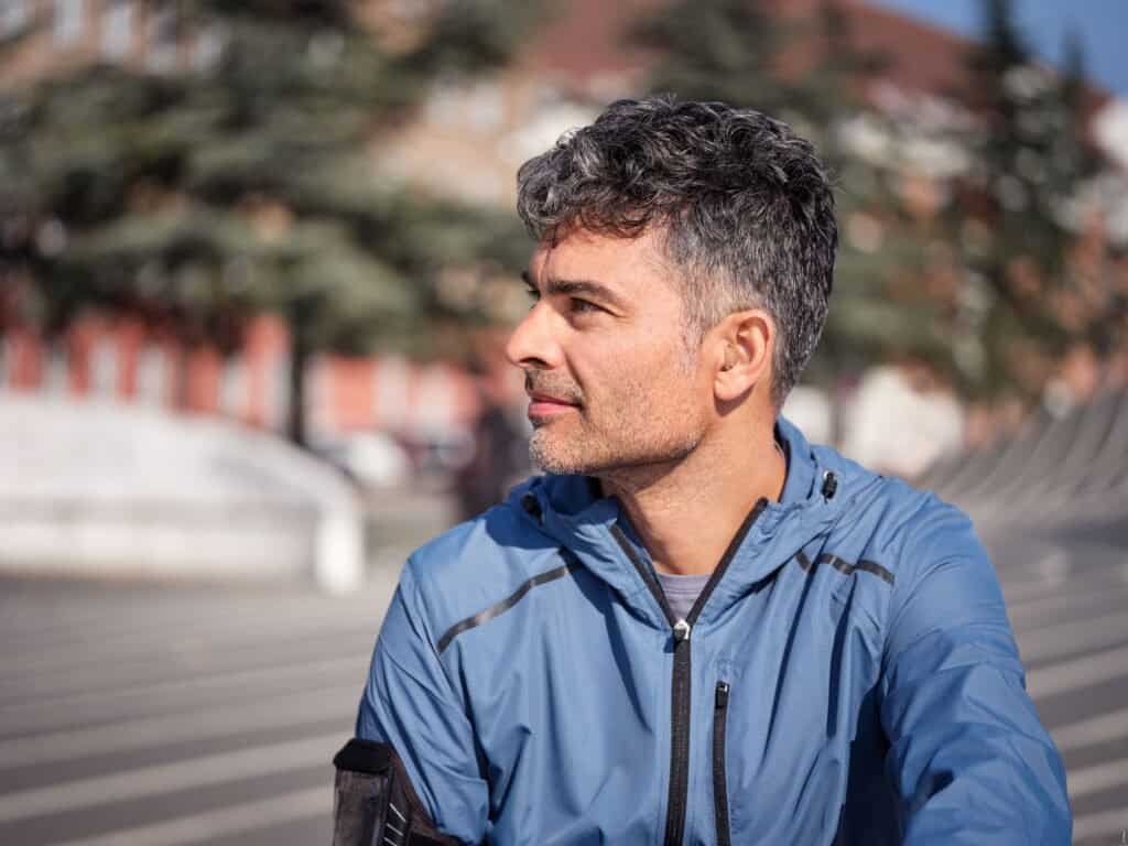 Custom in‑the‑ear hearing aid in a natural skin tone.