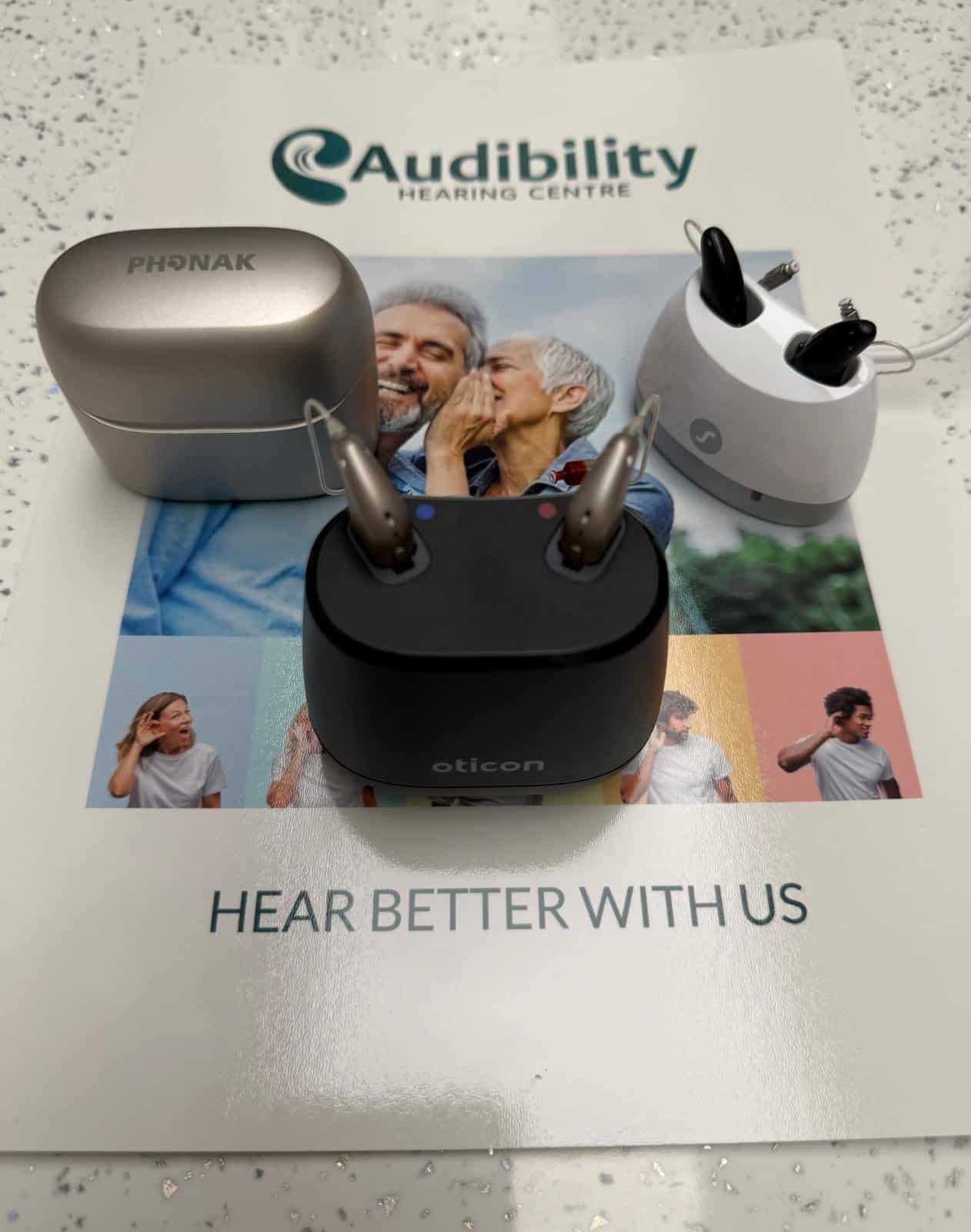 Phonak, Oticon and Signia hearing aids displayed together on an Audibility Hearing Centre brochure.